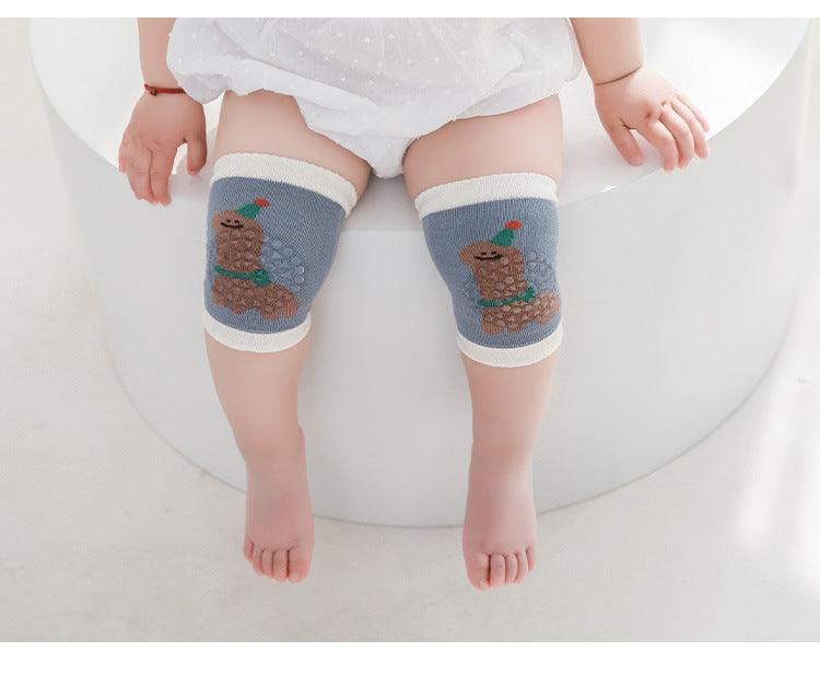 Baby wearing soft, cushioned knee sleeves for crawling protection