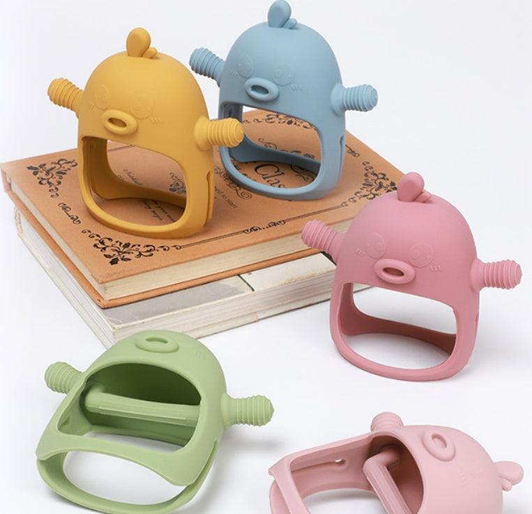 Colorful BabyTeethCare Soothing Gloves for teething relief on books