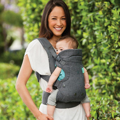 Mother carrying baby in a breathable baby carrier backpack outdoors.