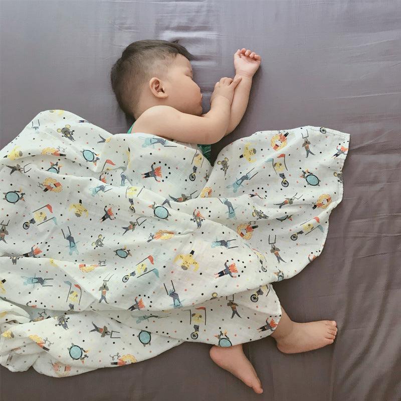 Baby sleeping in Cozy Cartoon Baby Wraps with colorful illustrations, providing comfort and style.