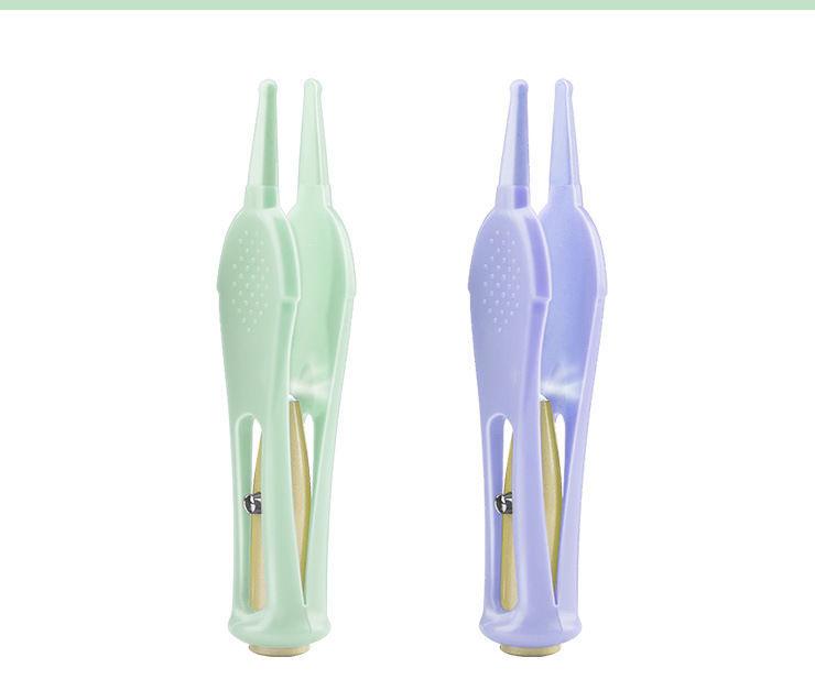 LumiNose Baby Cleansing Tool in mint green and lavender colors.