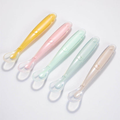 Silicone baby feeding spoons in various pastel colors on a white background.